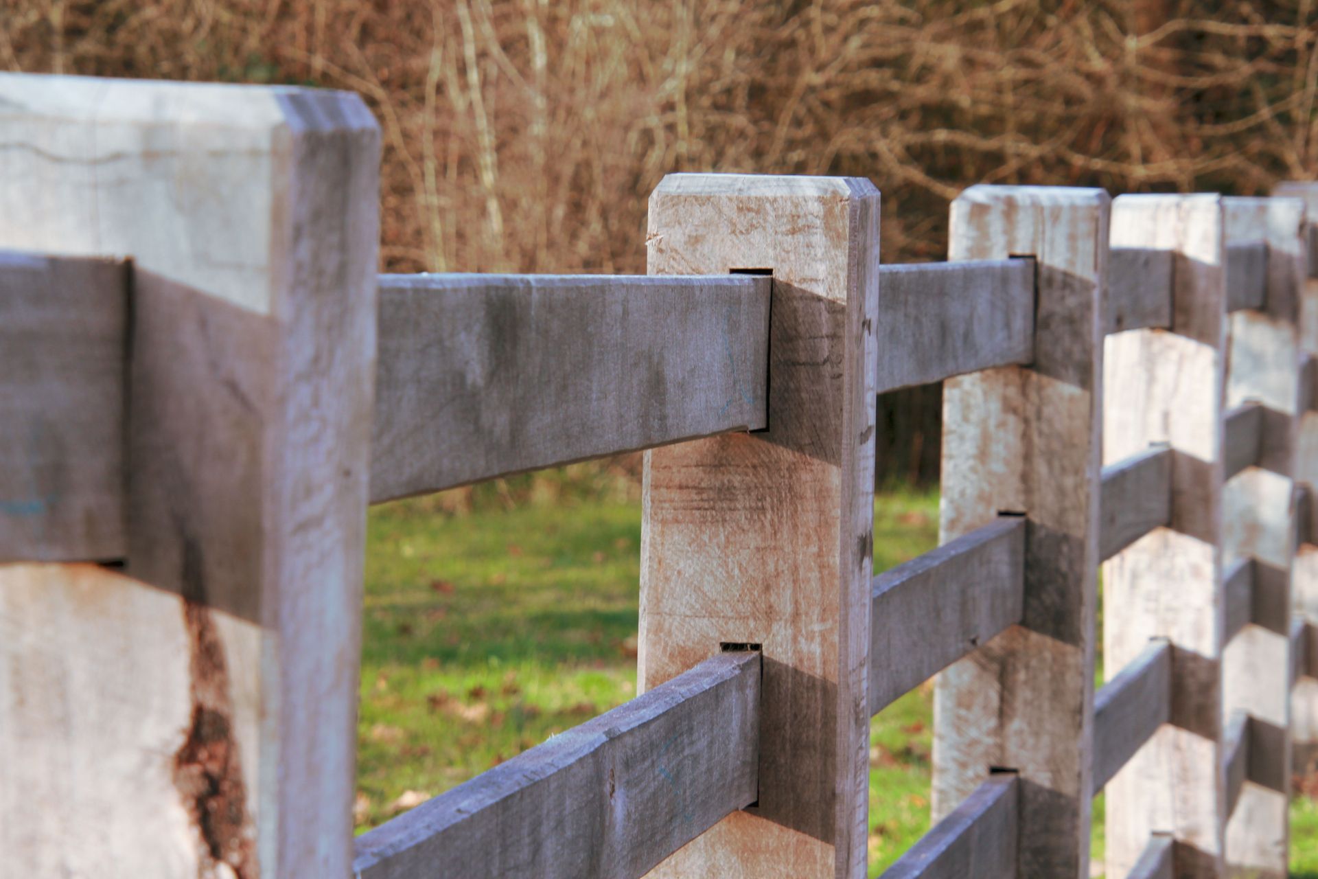 Detailed shot of a wooden fence with a natural background, capturing texture and depth.