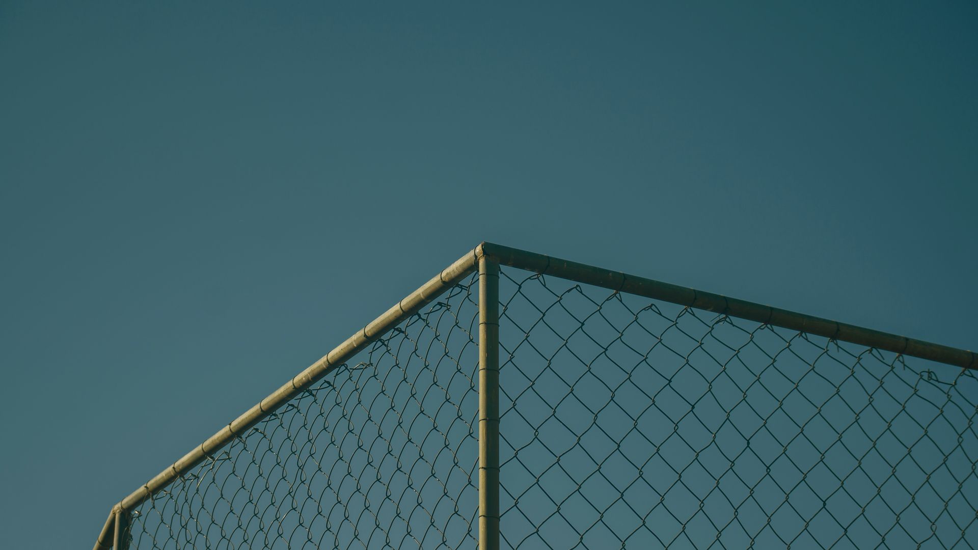 black metal fence under blue sky